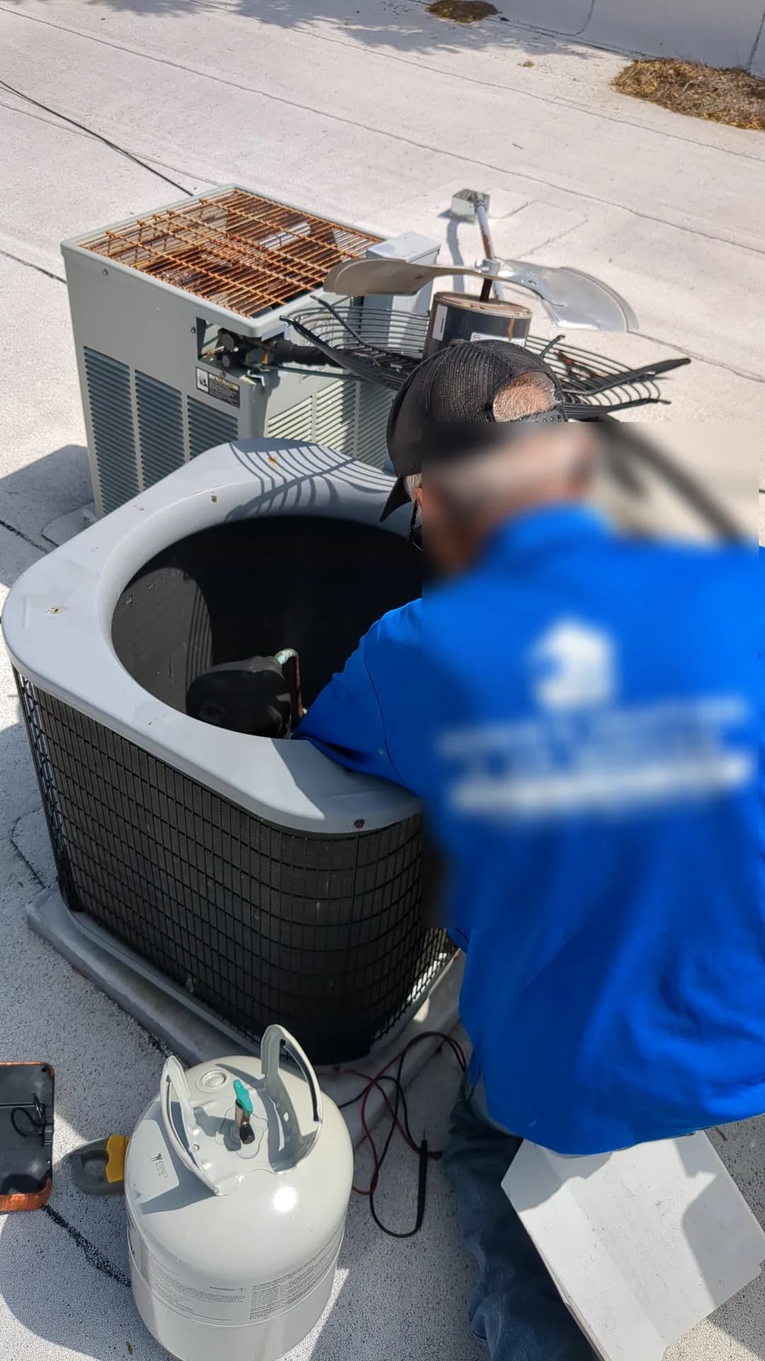Indoor Air Quality Chicago — Bernie's technician repairing an open commercial air-conditioning condenser