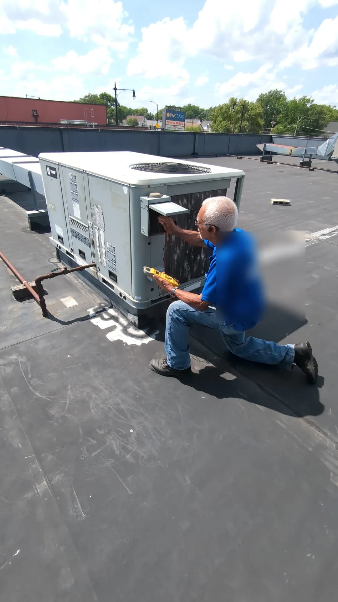 Expert HVAC Services for Chicago Homes — Bernie's technician servicing rooftop HVAC equipment in Chicago