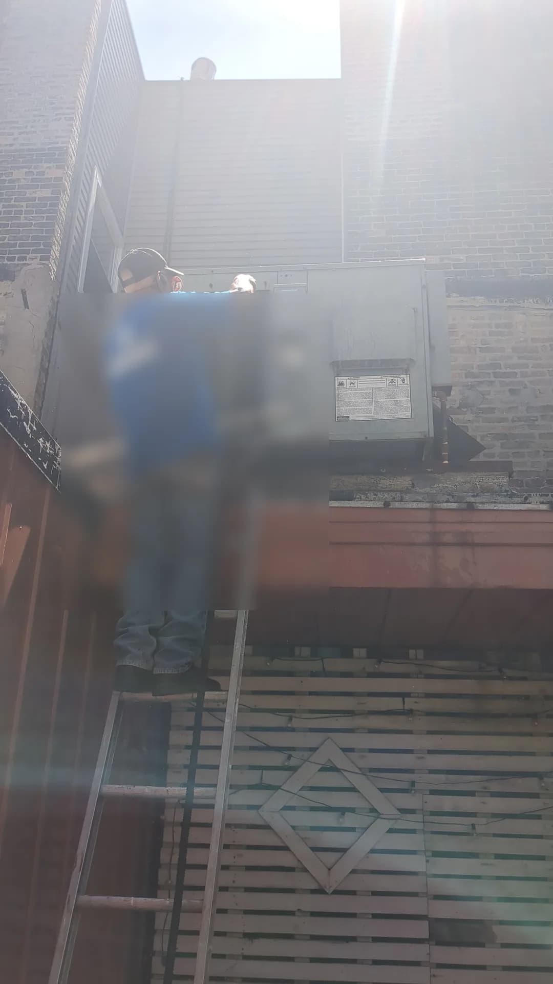 Duct Cleaning & Repair Chicago — technician servicing elevated commercial rooftop HVAC equipment