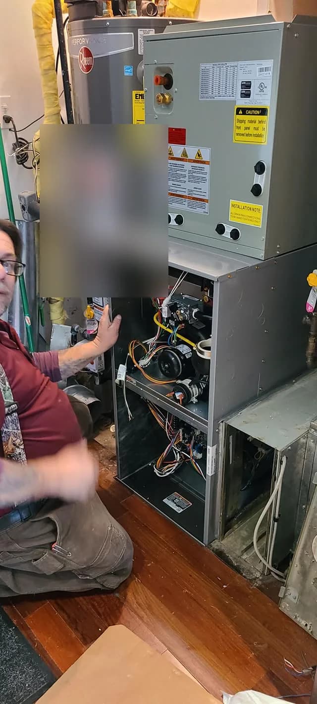 Furnace Blower Motor Repair Chicago — technician working beside an open high-efficiency furnace
