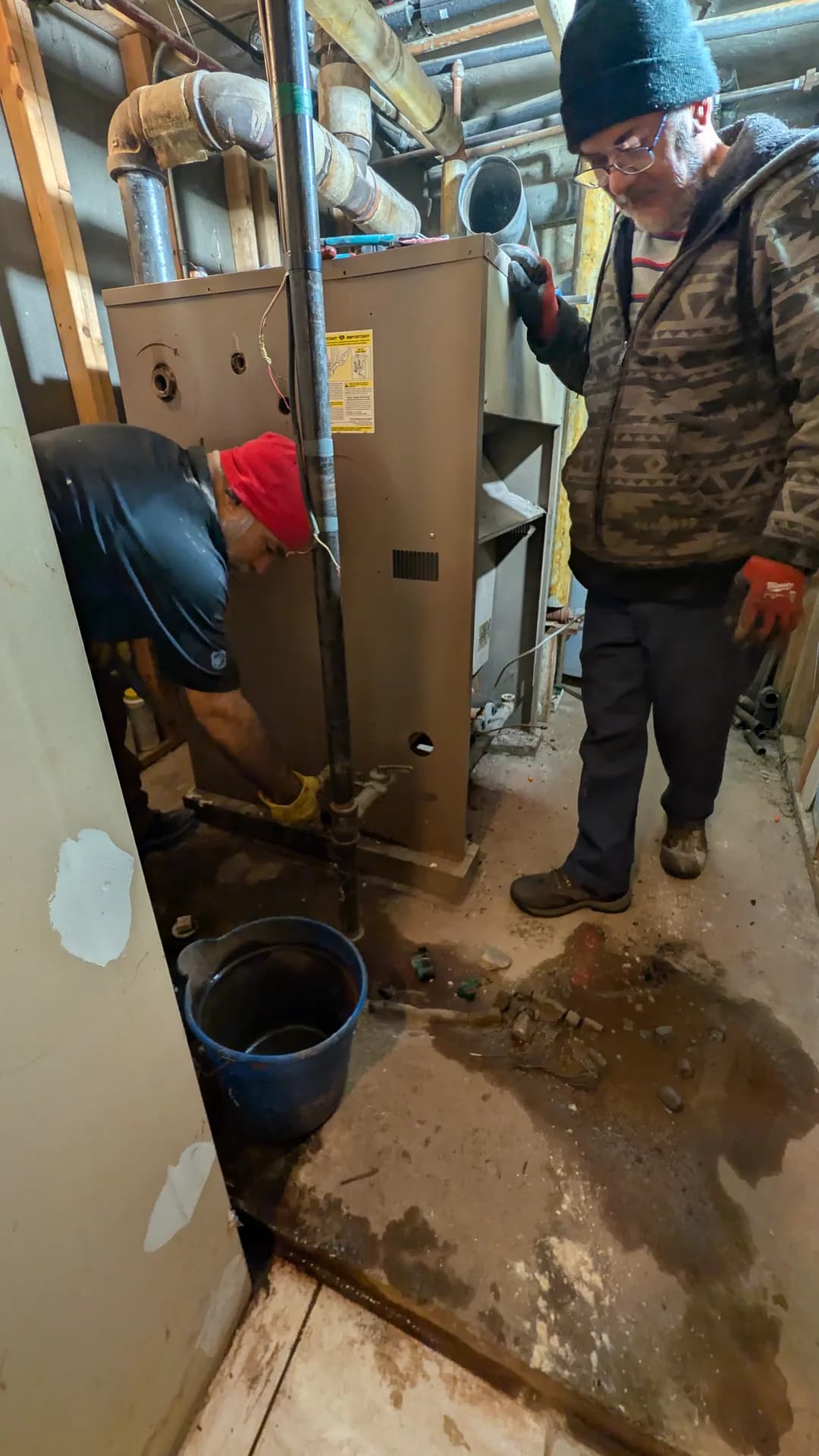 Boiler Replacement Services — technicians removing an old cast-iron steam boiler