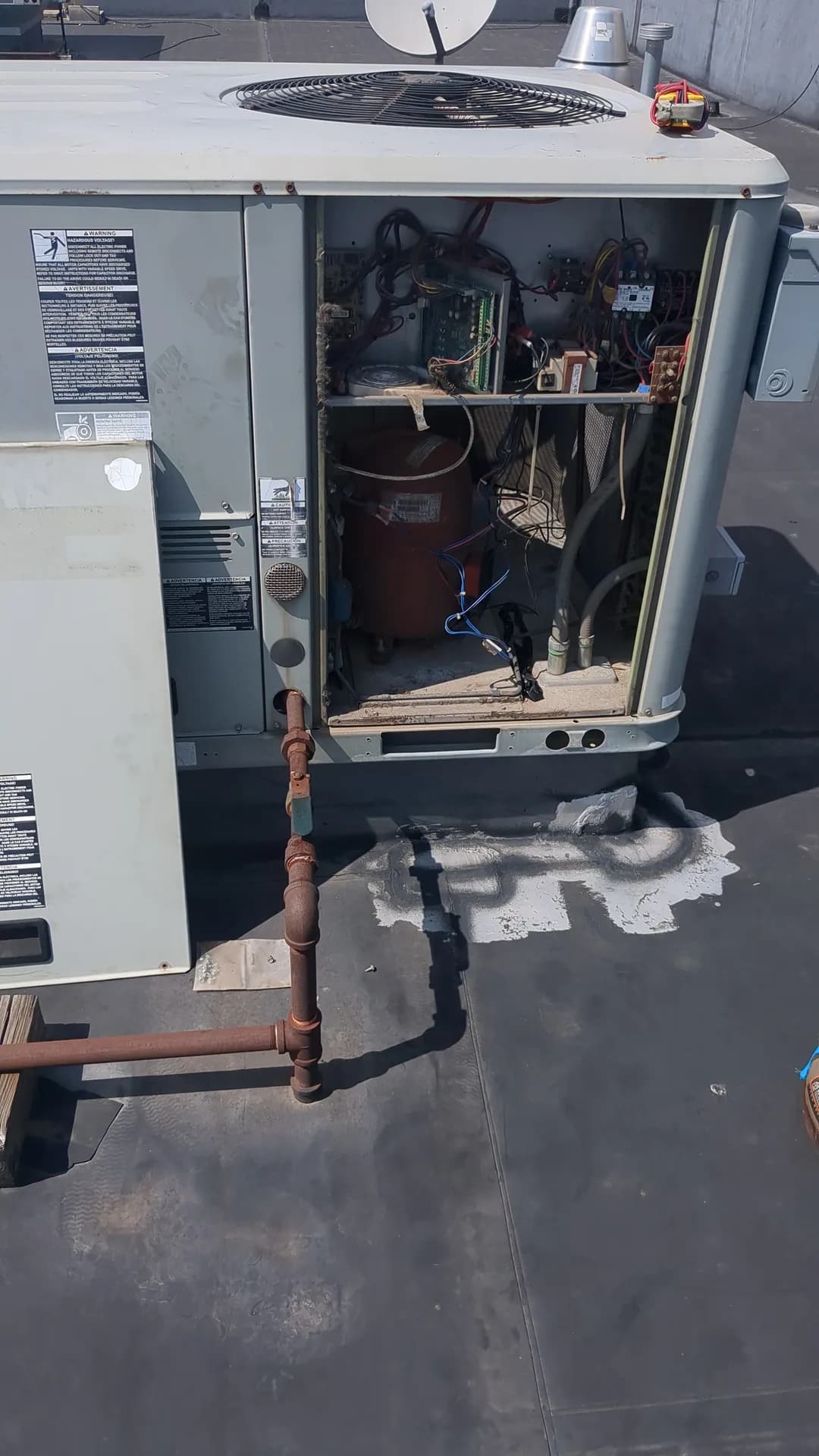 Complete AC System Design & Installation — open commercial rooftop HVAC equipment during service