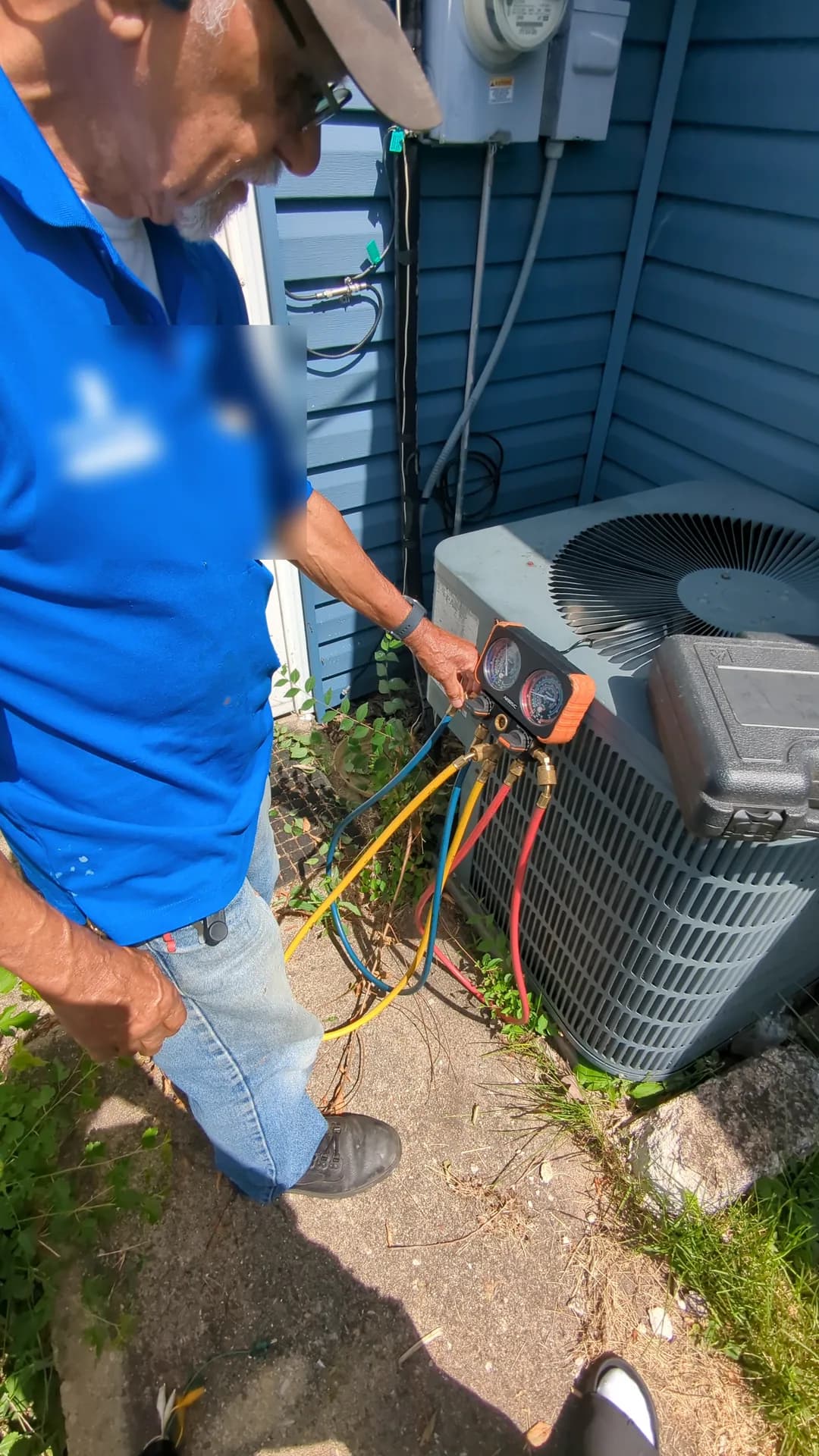 AC Refrigerant Leak Detection & Recharge — technician checking residential air-conditioner pressures with diagnostic gauges