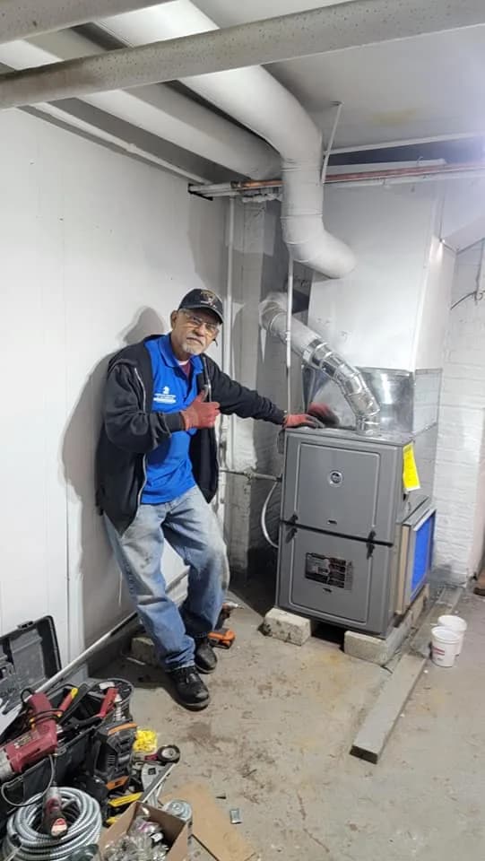Service Areas We Cover All of Chicago — Bernie's technician with a completed residential furnace