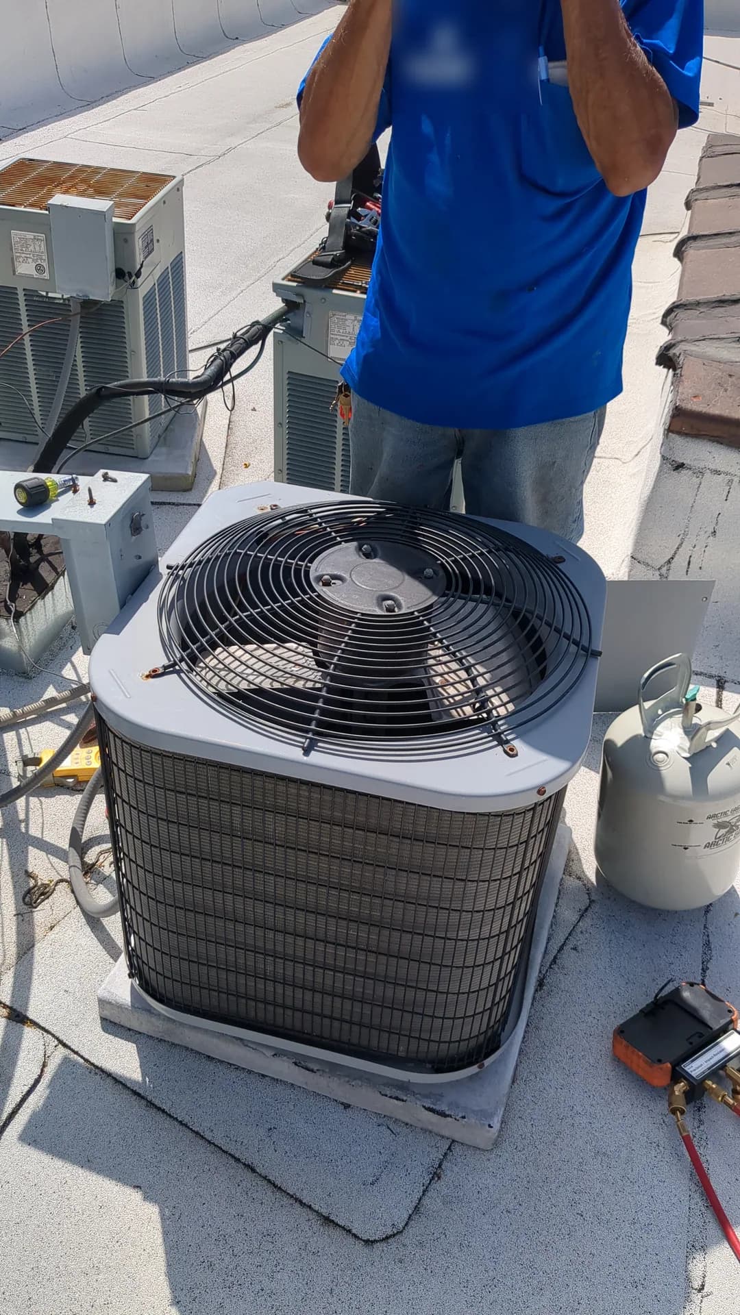 24-Hour AC Repair Service — technician servicing an air-conditioning condenser on a commercial roof