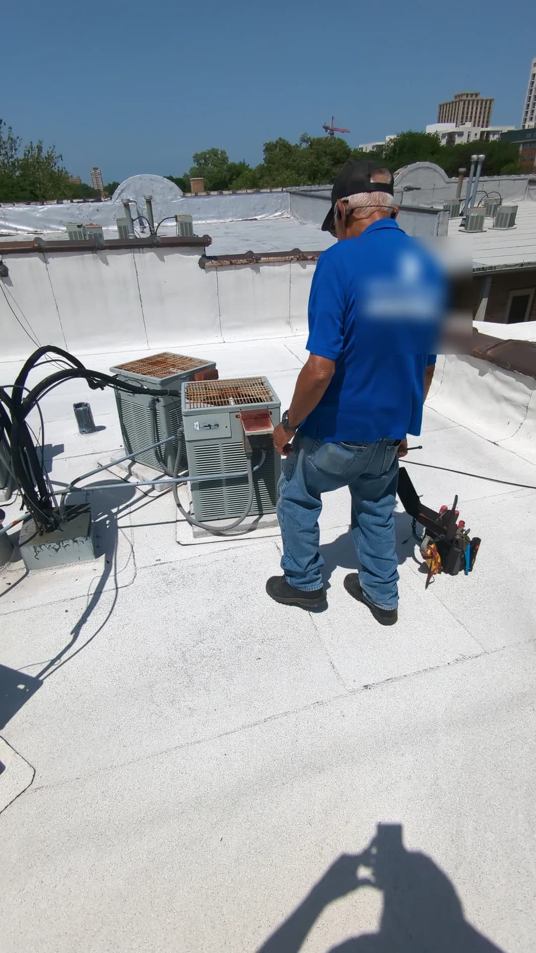 Geothermal Heating & Cooling Chicago — Bernie's technician servicing commercial rooftop air-conditioning equipment
